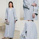 An embroidered cardigan dress with an elegant and modern design.